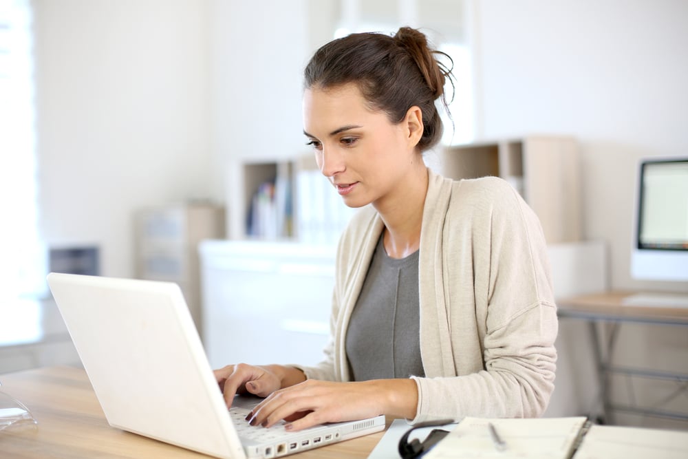 Women working in home office to find a digital marketing agency for her manufacturering business.