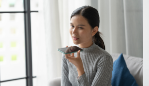 Young woman using voice search on her smartphone to find a local business in Northern Indiana and Michiana.